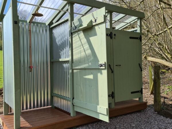 Outdoor showers at Wytch Wood Camping